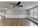 Bright living room featuring hardwood floors, a ceiling fan, and ample natural light at 5155 Rosestone Nw Dr, Lilburn, GA 30047