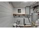 Utility room with updated wall paneling and shelves at 5155 Rosestone Nw Dr, Lilburn, GA 30047