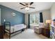 Cozy bedroom with a blue accent wall, soft carpet, and lots of natural light at 819 Holly Rdg, Canton, GA 30115
