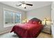 Comfortable bedroom with bright window, lamps, and a red comforter at 819 Holly Rdg, Canton, GA 30115
