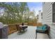 Outdoor deck with table, chairs, wicker couch, and green cushions at 819 Holly Rdg, Canton, GA 30115