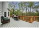 Spacious outdoor deck with grill, dining table, and wicker couch overlooking the yard at 819 Holly Rdg, Canton, GA 30115