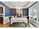 Formal dining room with elegant chandelier and large windows at 819 Holly Rdg, Canton, GA 30115