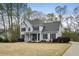 Traditional two-story home with a well-manicured lawn, mature trees, and a welcoming covered front porch at 819 Holly Rdg, Canton, GA 30115