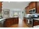 Open kitchen with granite countertops, stainless steel appliances, and hardwood floors at 819 Holly Rdg, Canton, GA 30115