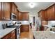 Well-lit kitchen with granite counters, stainless appliances, and access to the dining room at 819 Holly Rdg, Canton, GA 30115