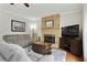 Cozy living room with a stone fireplace, comfortable seating, and a warm ambiance at 819 Holly Rdg, Canton, GA 30115