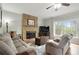 Comfortable living room features stone fireplace, neutral decor, and ample natural light at 819 Holly Rdg, Canton, GA 30115