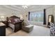 Spacious main bedroom with a tray ceiling, large windows, and ample natural light at 819 Holly Rdg, Canton, GA 30115