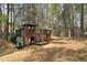 Community playground nestled in a wooded area with slides, climbing structures, and swings at 819 Holly Rdg, Canton, GA 30115