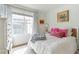 Bedroom featuring a cozy bed, accent pillows, and natural lighting at 4460 Dalston Ne Dr, Atlanta, GA 30342