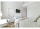 Spacious bedroom with white walls, tv, closet, and overhead fan at 4460 Dalston Ne Dr, Atlanta, GA 30342