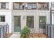 Charming townhome exterior featuring a cozy balcony and stylish front door with attractive landscaping at 4460 Dalston Ne Dr, Atlanta, GA 30342