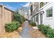 Side yard view of townhome with manicured landscaping and private walkway at 4460 Dalston Ne Dr, Atlanta, GA 30342