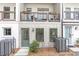 Street view of townhome exterior with two stories, green door, and iron-wrought balcony at 4460 Dalston Ne Dr, Atlanta, GA 30342
