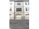 Townhome garages with white doors and paved driveway at 4460 Dalston Ne Dr, Atlanta, GA 30342