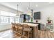 Modern kitchen featuring a large island with seating, pendant lights, and stainless steel appliances at 4460 Dalston Ne Dr, Atlanta, GA 30342
