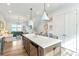Bright kitchen featuring a large island, stainless steel appliances, and an open view to the living room at 4460 Dalston Ne Dr, Atlanta, GA 30342
