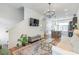 Modern living room showcasing open layout, sleek floors, stylish decor, and seamless flow to kitchen at 4460 Dalston Ne Dr, Atlanta, GA 30342