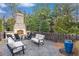 Outdoor fireplace and sitting area with chairs and blue accent vase at 4460 Dalston Ne Dr, Atlanta, GA 30342