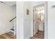 Hallway view of charming powder room with wood floors and modern vanity with rounded mirror at 4460 Dalston Ne Dr, Atlanta, GA 30342