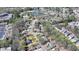An aerial view showing the home nestled in a neighborhood with trees and adjacent pond at 5190 Deerlake Dr, Alpharetta, GA 30005