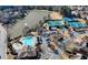 An aerial view showing a serene lake alongside multiple tennis courts, pool and clubhouse at 5190 Deerlake Dr, Alpharetta, GA 30005