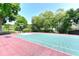 A view of the community basketball court, surrounded by trees and shrubbery at 5190 Deerlake Dr, Alpharetta, GA 30005