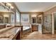 Bright bathroom with marble counters, a soaking tub, and a tiled glass shower at 5190 Deerlake Dr, Alpharetta, GA 30005