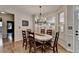 Bright dining area featuring plantation shutters and classic chandelier at 5190 Deerlake Dr, Alpharetta, GA 30005