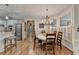 Open dining area with a chandelier and breakfast bar is adjacent to kitchen at 5190 Deerlake Dr, Alpharetta, GA 30005