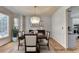 Elegant dining room features modern chandelier, hardwood floors, and decorative wainscoting at 5190 Deerlake Dr, Alpharetta, GA 30005