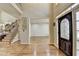 Spacious foyer with hardwood flooring, staircase, and decorative front door at 5190 Deerlake Dr, Alpharetta, GA 30005