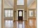 Welcoming foyer with hardwood floors, lots of light, and decorative front door at 5190 Deerlake Dr, Alpharetta, GA 30005