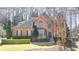 Charming two-story brick home featuring well-manicured landscaping and a welcoming front entrance at 5190 Deerlake Dr, Alpharetta, GA 30005