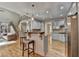 Open kitchen with a breakfast bar, granite countertops, and hardwood floors connects living spaces at 5190 Deerlake Dr, Alpharetta, GA 30005