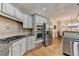 Modern kitchen features stainless steel appliances, gray cabinets, and granite countertops at 5190 Deerlake Dr, Alpharetta, GA 30005