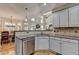 Kitchen with granite countertops, stainless steel appliances, and white cabinets overlooking a dining area at 5190 Deerlake Dr, Alpharetta, GA 30005