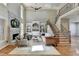 Bright living room with hardwood floors, built-in shelving, and a cozy seating area at 5190 Deerlake Dr, Alpharetta, GA 30005