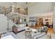 Open-concept living room with a staircase, views into the kitchen, and hardwood floors at 5190 Deerlake Dr, Alpharetta, GA 30005
