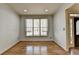 Living room with a window, hardwood floors, and neutral wall color at 5190 Deerlake Dr, Alpharetta, GA 30005