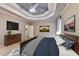 Serene primary bedroom with decorative tray ceilings, plush bedding, and a warm, inviting ambiance at 5190 Deerlake Dr, Alpharetta, GA 30005