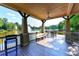 The outdoor covered seating area overlooks the serene pond with a fountain at 5190 Deerlake Dr, Alpharetta, GA 30005