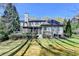 Exterior view of the home's backyard, featuring a deck, patio, and well-manicured lawn at 5190 Deerlake Dr, Alpharetta, GA 30005