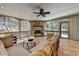 Inviting screened porch features a stone fireplace, tile floors, and comfortable seating for relaxation and entertaining at 5190 Deerlake Dr, Alpharetta, GA 30005