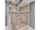 Modern bathroom shower with glass enclosure, tile surround, and mosaic accents for a spa-like experience at 5190 Deerlake Dr, Alpharetta, GA 30005