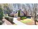 A lovely two-story brick home shows off the driveway and two car garage at 5190 Deerlake Dr, Alpharetta, GA 30005