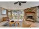 Bright sunroom with stone fireplace and comfortable seating at 5190 Deerlake Dr, Alpharetta, GA 30005