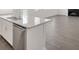 Close-up of kitchen island with stainless steel dishwasher and gray wood flooring at 534 Nolden Trl, Dacula, GA 30019