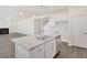 Kitchen island with granite countertop and sink, with views of the living room and fireplace at 534 Nolden Trl, Dacula, GA 30019